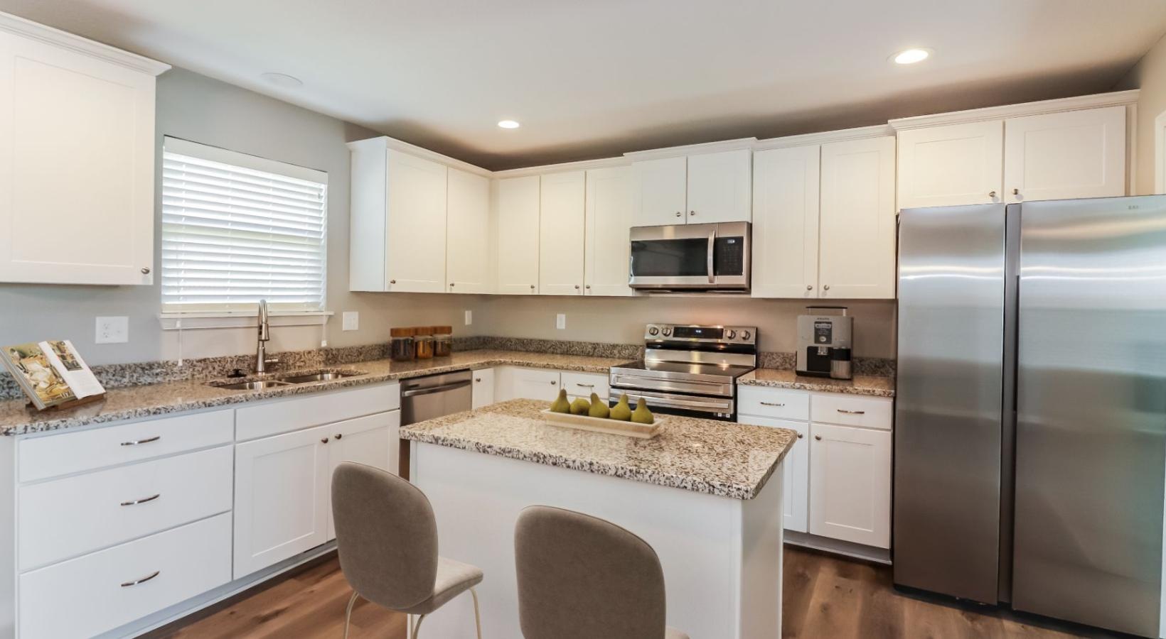 Spacious kitchens with thoughtful details a kitchen with white cabinets