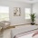 a bedroom with a bed and a chair