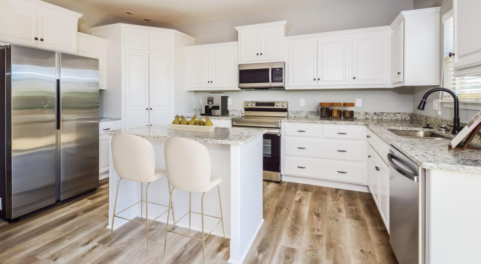 Spacious kitchens with thoughtful details a kitchen with white cabinets