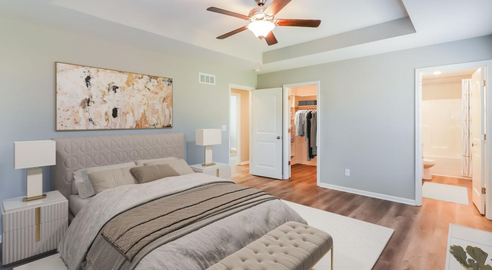 Relax and recharge in beautiful and spacious bedrooms a bedroom with a bed and a fan