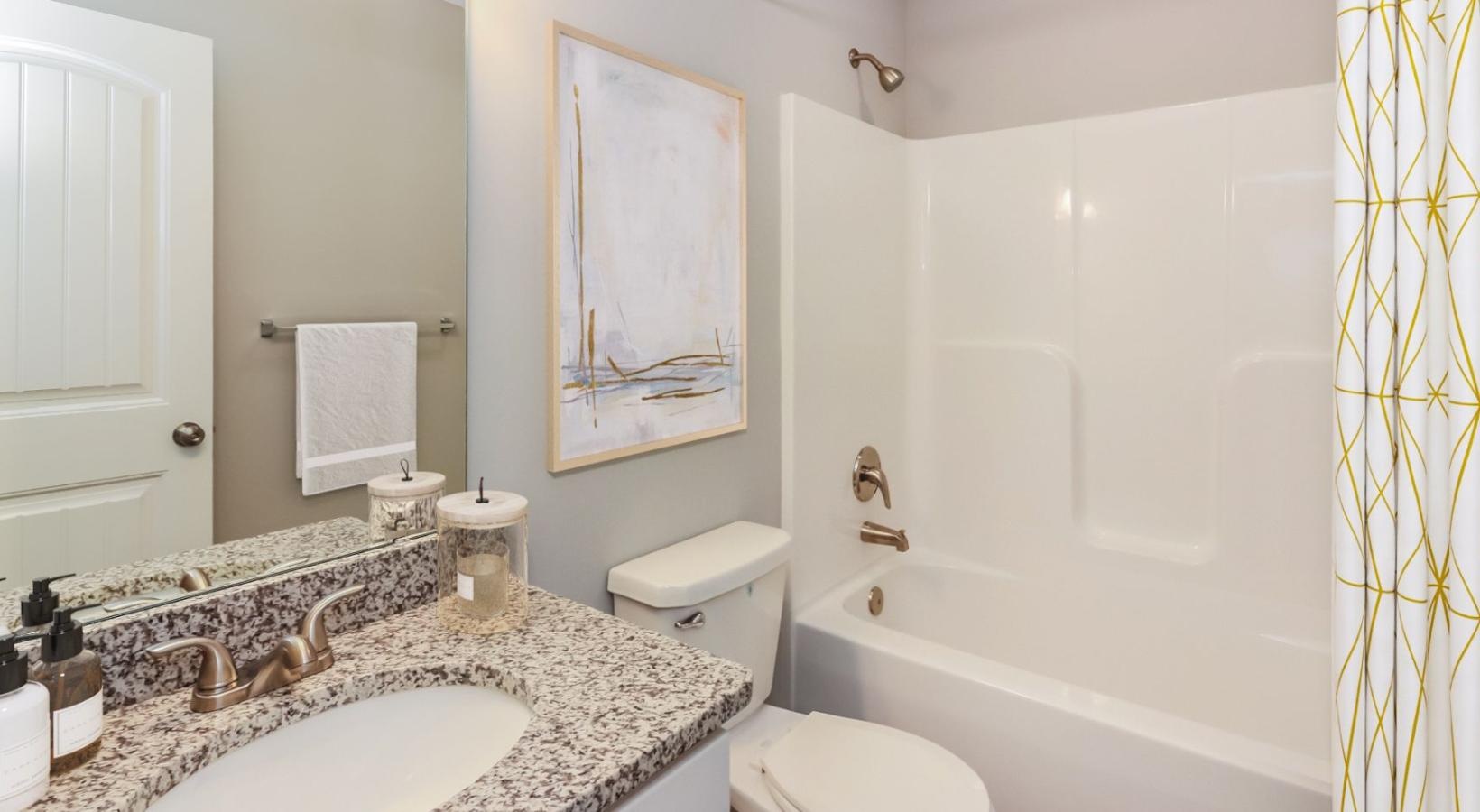 Bathroom options with thoughtful details a bathroom with a tub sink and toilet
