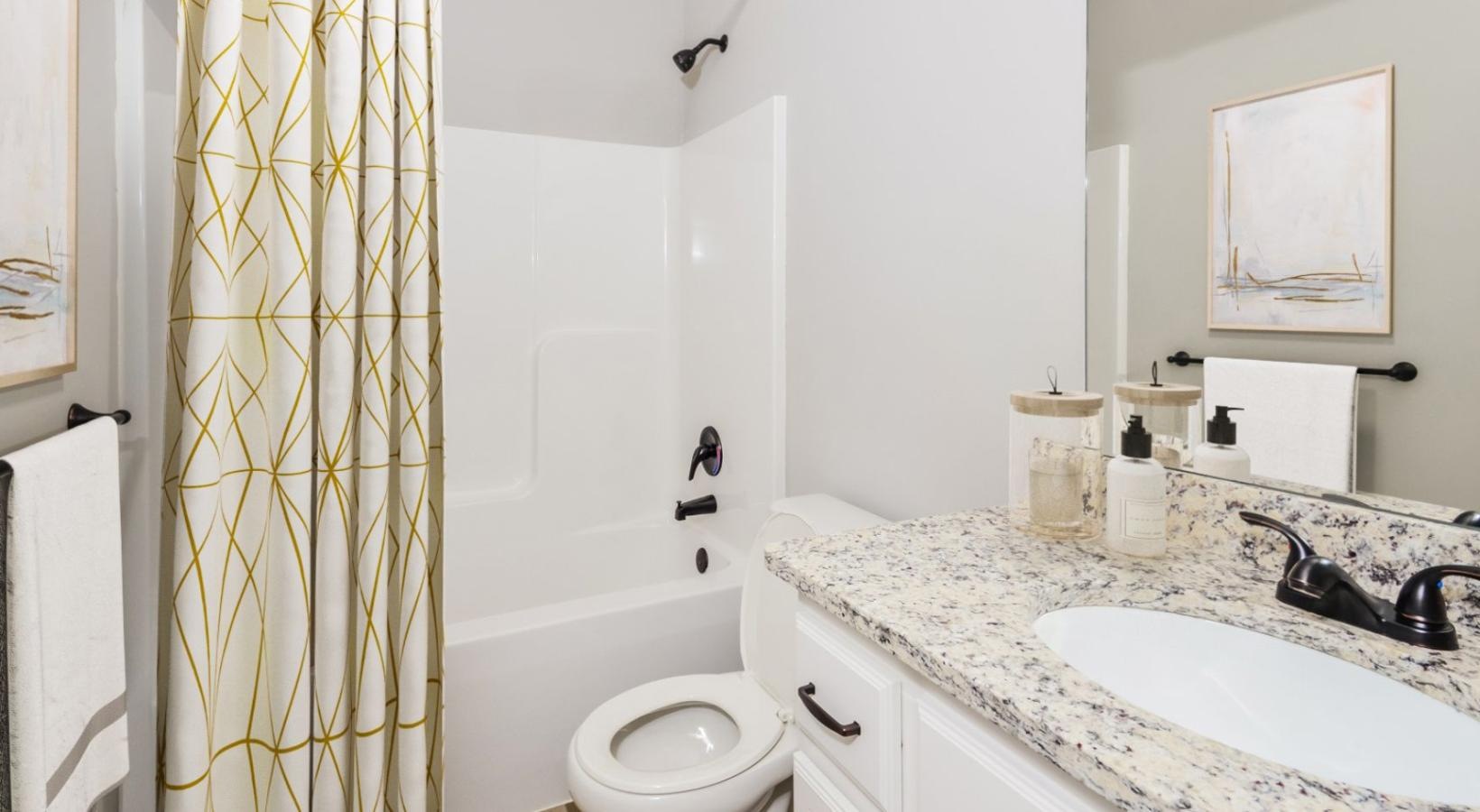 Spacious bathrooms with everything you need a bathroom with a sink toilet and bathtub